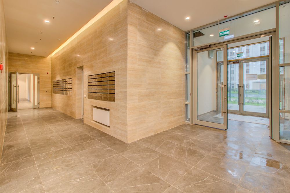 Hall d'entrée accessible d'un immeuble collectif neuf avec cheminement sans ressaut conforme aux normes PMR