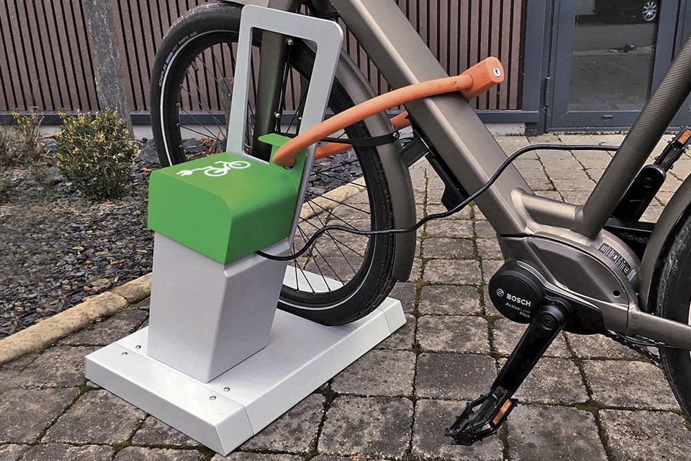 Arceaux de stationnement pour vélos avec prise électrique de recharge, aménagement recommandé dans un local à vélo collectif