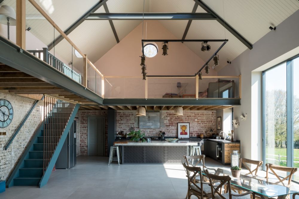 Intérieur d'une grange en pierre avec charpente apparente en cours de conversion en logement