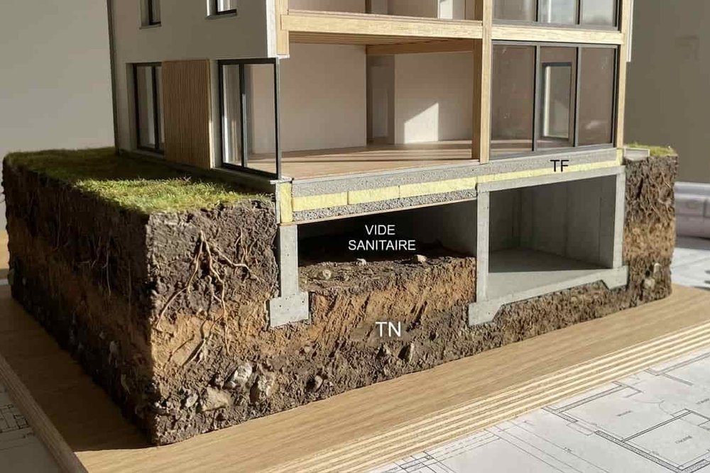 Dessin technique montrant la coupe d'une maison sur vide sanitaire avec altimétrie du terrain naturel et fini
